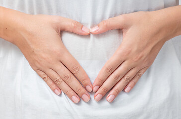 Heart shaped hands of woman on t-shert