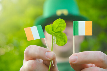 St.Patrick 's Day. Ireland flag and clover flowers close-up in sunbeams.Saint Patrick background....