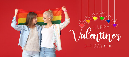 Young lesbian couple with LGBT flag on color background. Valentine's Day celebration