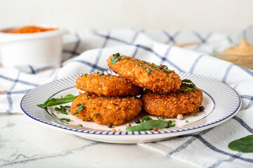 Plate with tasty lentil cutlets on table