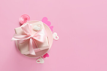 Present for Valentine day, hearts and rose bud on color background