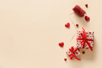 Gifts for Valentine day and decorative hearts on color background