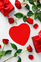 Composition with blank card, red rose flowers and gifts for Valentine's Day on white background