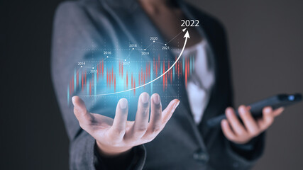 Financial graph showing increase of price in stock market 2022, internet trading and Forex concept, businesswoman showing virtual digital graph on palm
