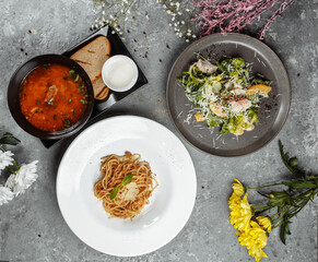 Three-course set menu for a nutritious healthy lunch in a restaurant, Three course set on a table in a business lunch, food set lunch. pasta borsch salad