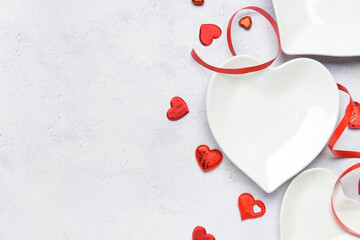 Beautiful heart shaped plates on white background
