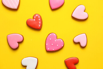 Tasty heart shaped cookies on yellow background