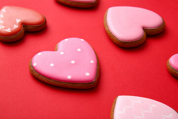 Tasty heart shaped cookies on red background
