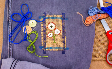 Visible mending on jeans, creative sustainable fashion, repair, mend and recycle. slow fashion make...