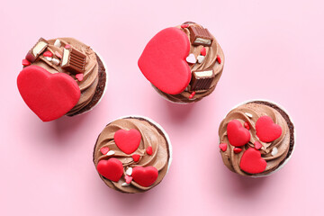 Tasty chocolate cupcakes for Valentine's Day on pink background