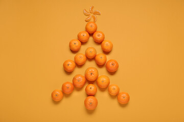 Christmas tree made of sweet tangerines on color background