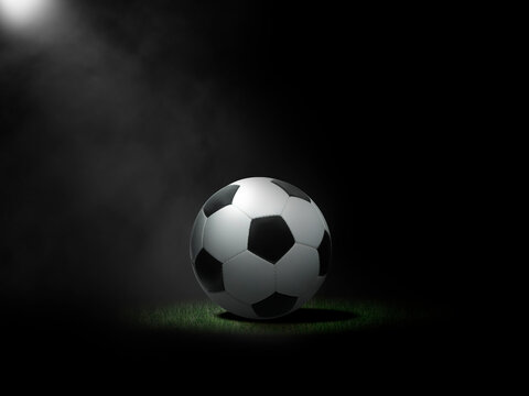 Soccer ball on lawn with black background