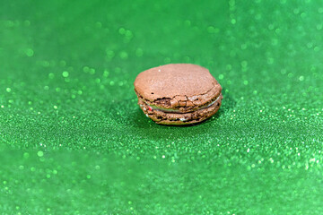 brown chocolate dessert delicious macaroon on a green white background. side view