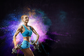 Obraz premium Young beautiful girl doing exercise against dark background