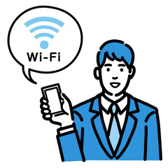 スマートフォンを持ってWi-Fiの説明をしているスーツを着た若い男性
