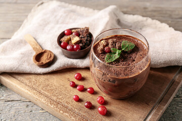 Glass of sweet cocoa dessert on table