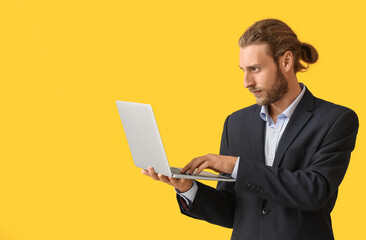 Man with laptop on color background