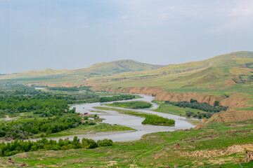 Fototapeta na wymiar mesmerizing view of the river and the Uplistsikhe mountains