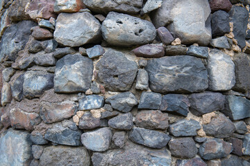 the fortress wall is lined with stones of different sizes