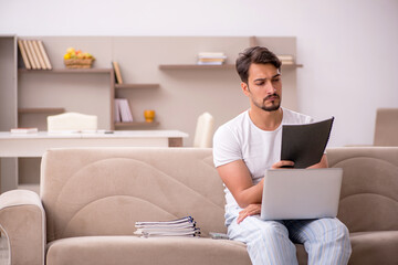 Young male employee working from home during pandemic