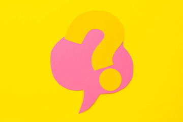 Question mark and speech bubble made of paper on yellow background