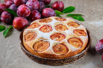 Delicious plum pie covered with powdered sugar.