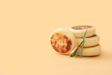 Tasty cottage cheese pancakes on beige background