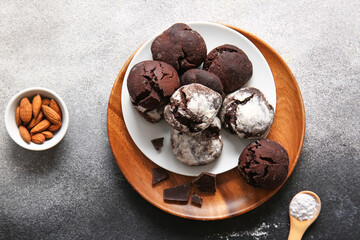 Plates of chocolate brownie cookies on grunge background