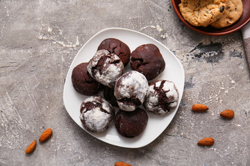 Plate of chocolate brownie cookies on grey background