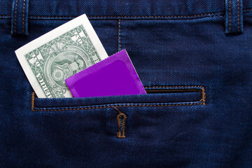 US dollar and condom in the pocket of blue jeans. Protect yourself Use a condom.
