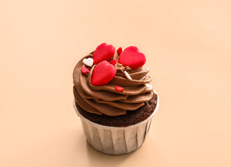 Tasty chocolate cupcake for Valentine's Day on beige background