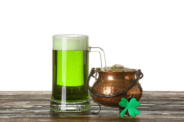 Glass of beer and pot with coins on table against white background background. St. Patrick's Day celebration