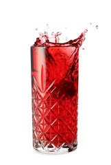 Glass of tasty pomegranate juice with splashes on white background