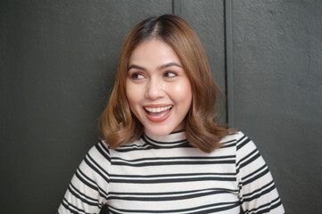 Fototapeta premium portrait of young beautiful short hair woman over black background