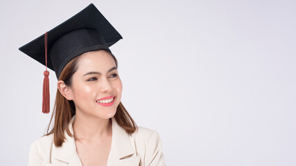 Portrait of young woman graduated over white background.