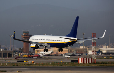 Fototapeta na wymiar Airplane lands at the airport of Barcelona. Spain