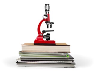 The scientific microscope on a stack of study books