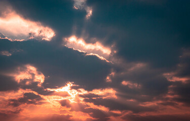 dramatic orange sky with bleeding sun rays at dawn