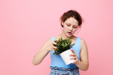 funny girl potted flower posing plant pink background unaltered