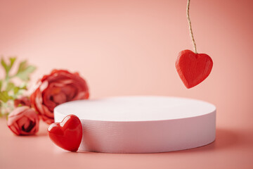 Pink empty podium with red heart over pastel background to show cosmetic products. Minimal romantic...
