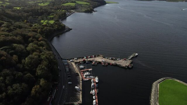 Aerial view of Bantry Ireland pier, bay and green landscape on sunny day - drone shot