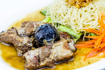 Baked pork ribs with noodle on white plate, Thai style food on white background