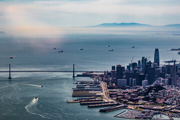 View of the Embarcadero Area of Downtown San Francisco with Ships Sailing by the San Francisco-Oakland Bay Bridge in San Francisco, California, USA