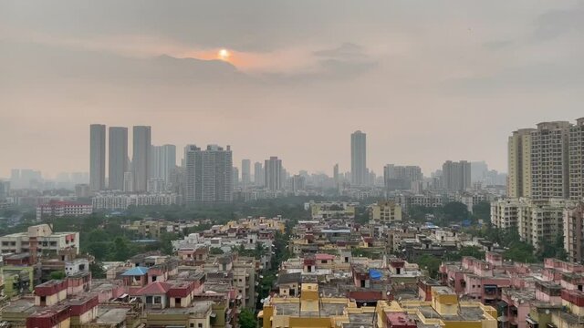Aerial slow tilt up shot of Thane city during sunset, India