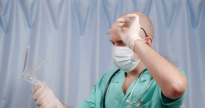 The doctor examines the gynecological device.