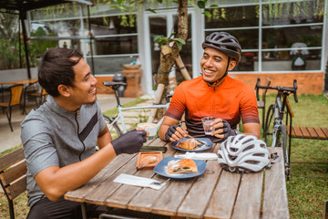 two cyclist enjoying coffee in the cafe after riding