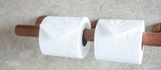 Woman hand pulling toilet paper in restroom. Cleaning, Lifestyle and personal hygiene concept