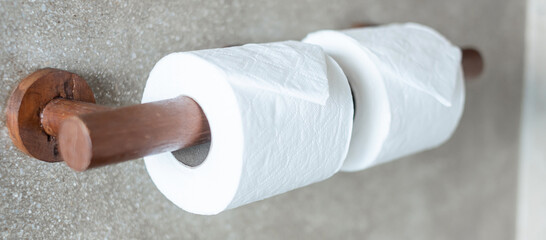 Woman hand pulling toilet paper in restroom. Cleaning, Lifestyle and personal hygiene concept
