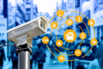 CCTV security camera on a building and night cityscape view on background. Concept of IOT...