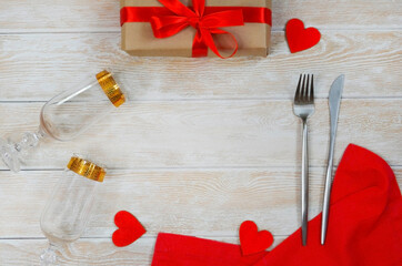 valentines day table setting flat lay with shape heart, festive decoration, fork and knife and red eco friendly zero waste gift box copy space text